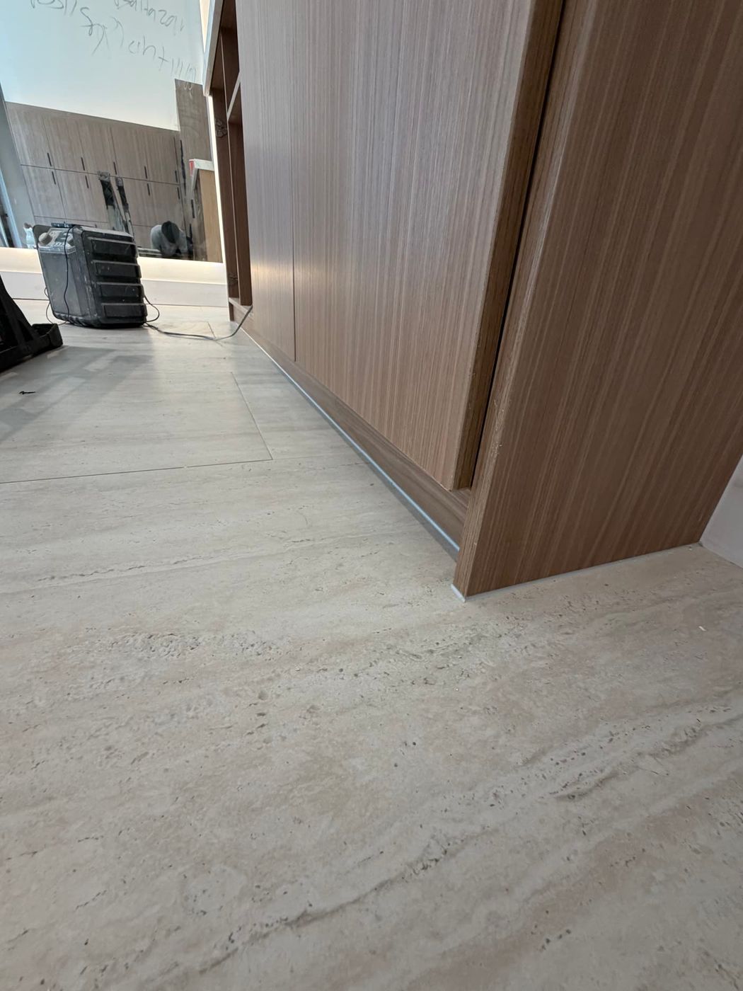 Finished seal along custom wood cabinetry and stone flooring