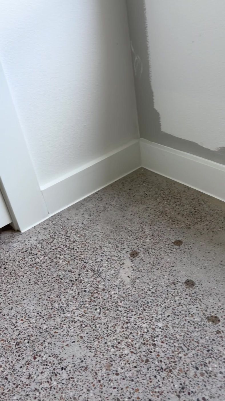 Clean white baseboard seams finished around an interior corner